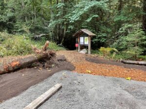 Newly graveled parking area with trailhead in the background